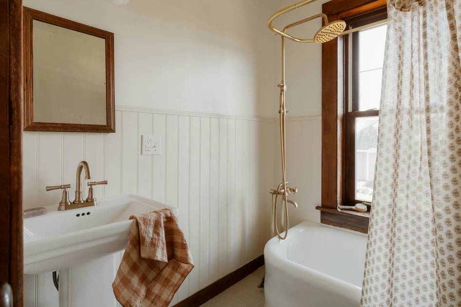 Close-up of ornate clawfoot tub legs in soft lighting
