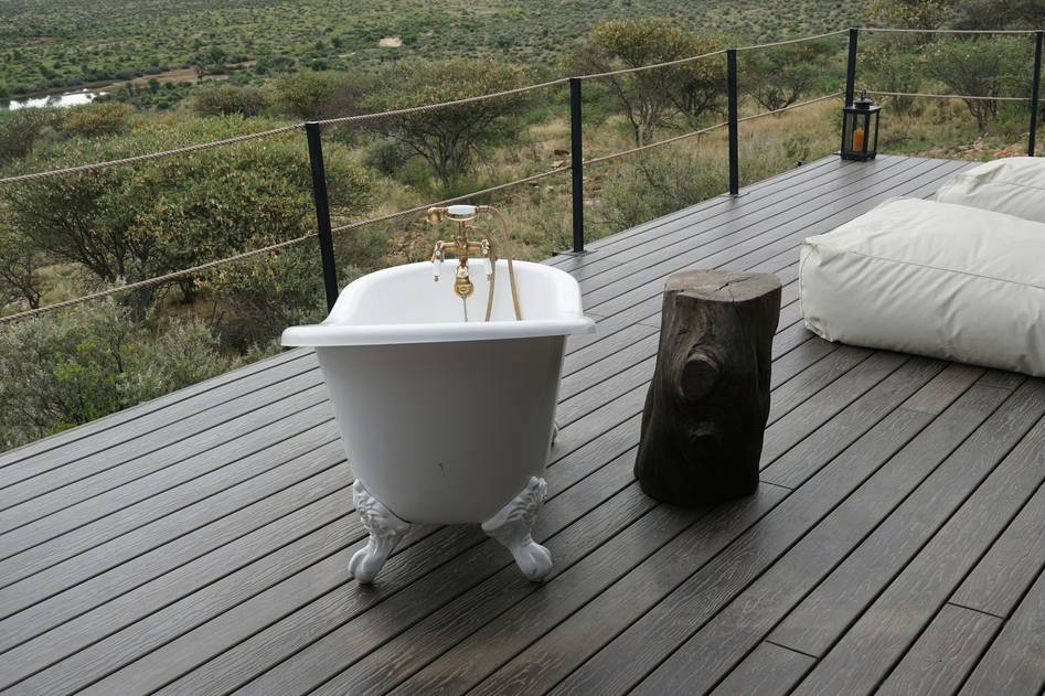 Cozy bathroom featuring restored clawfoot bathtub with towels