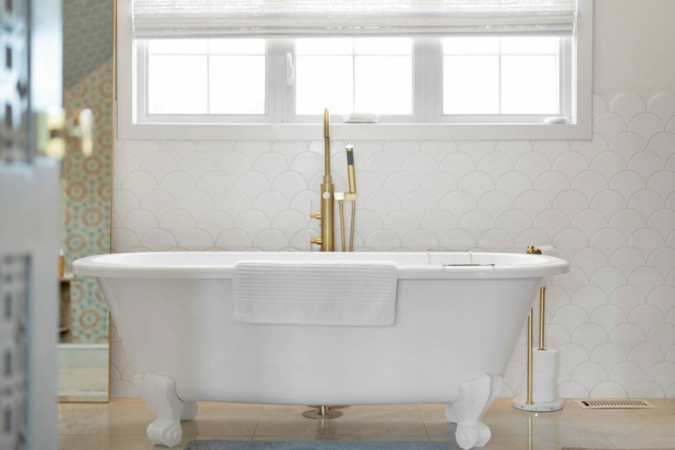 Vintage clawfoot bathtub with brass feet in elegant bathroom