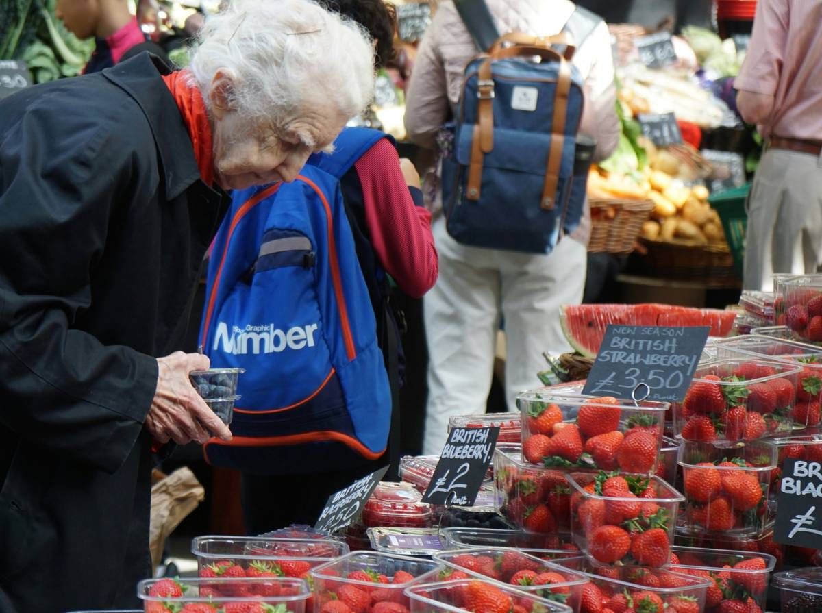 Old Caucasian woman shopping for fruit